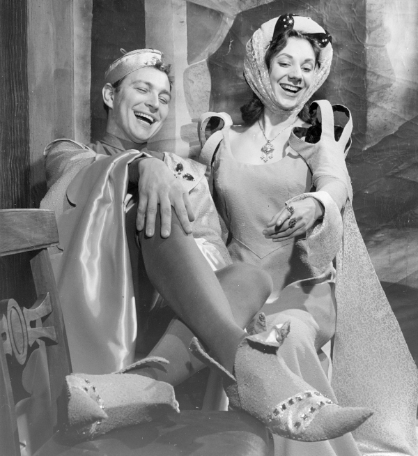 A man and woman in shakespearian costumes reclining and laughing 