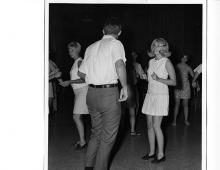 Young people dancing in a dark room