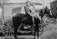 Man on a horse in front of a carriage with 'Smallpox' written on the side