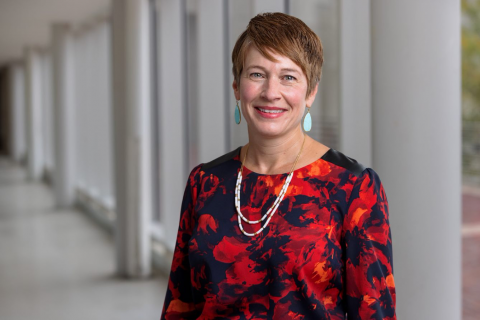 Dean Kristi Palmer head shot in front of white columns