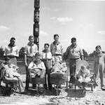 Boy Scouts posing in front of Native American totem pole